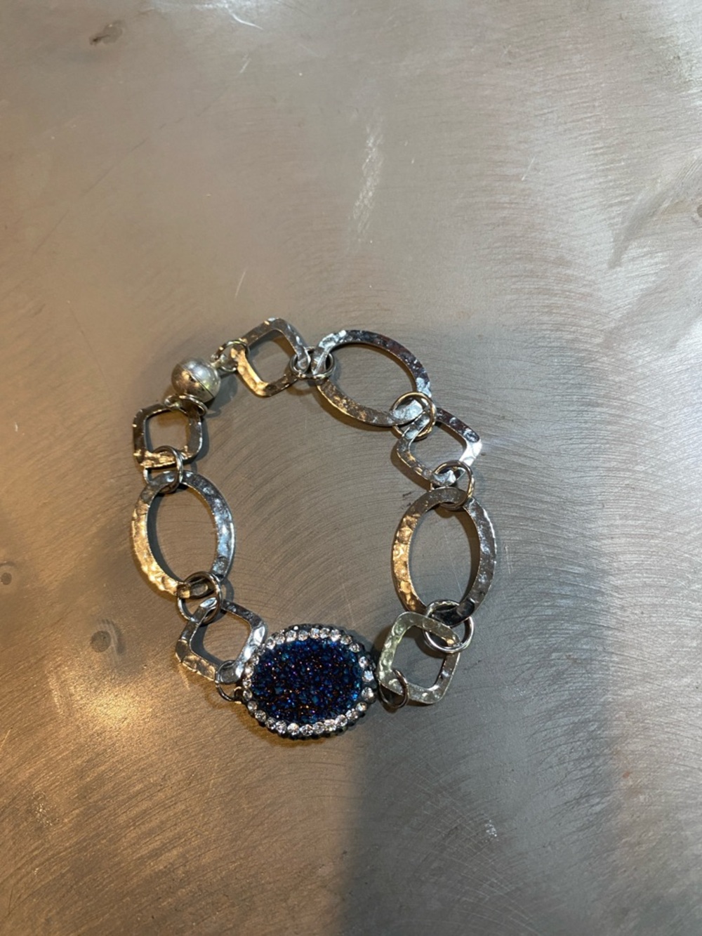 Silver pounded bracelet with blue druzy. Magnetic closure